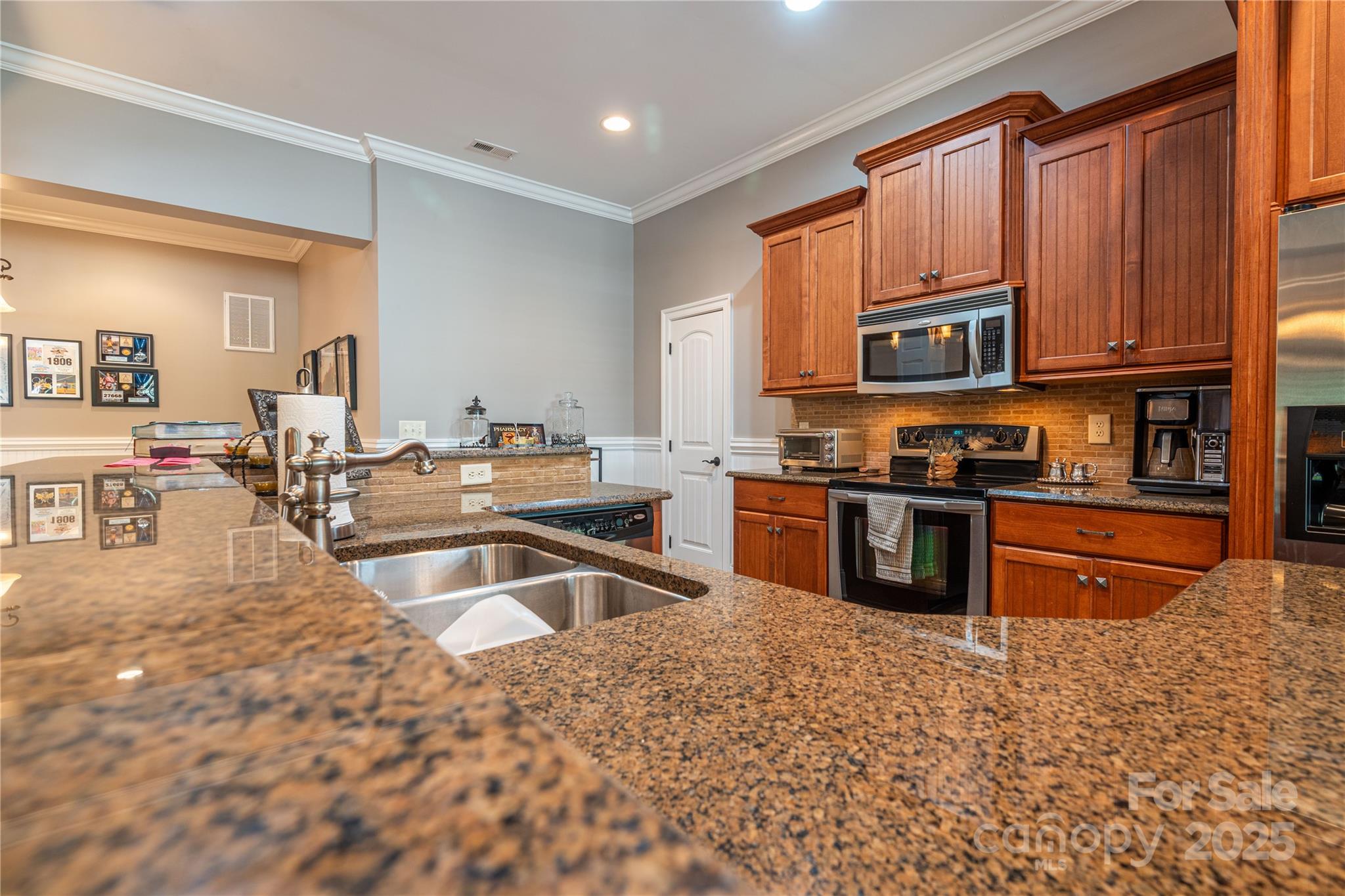 1427 Merrimont Avenue Kings Mountain, NC 28086 - Photo 36 of 48 a kitchen with stainless steel appliances granite countertop a stove sink and cabinets