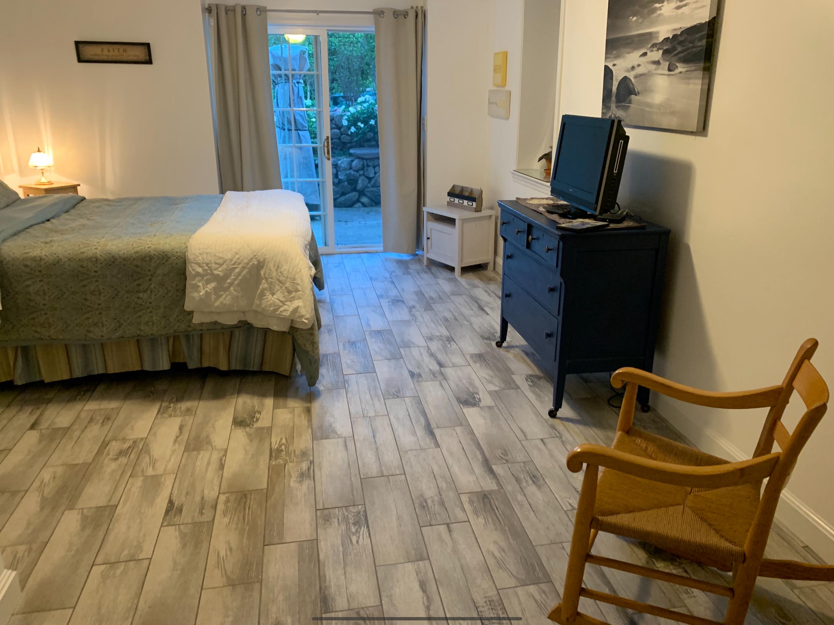 8 Fresh Pond Road Oak Bluffs, MA 02557 - Photo 25 of 36 a bedroom with a bed and wooden floor