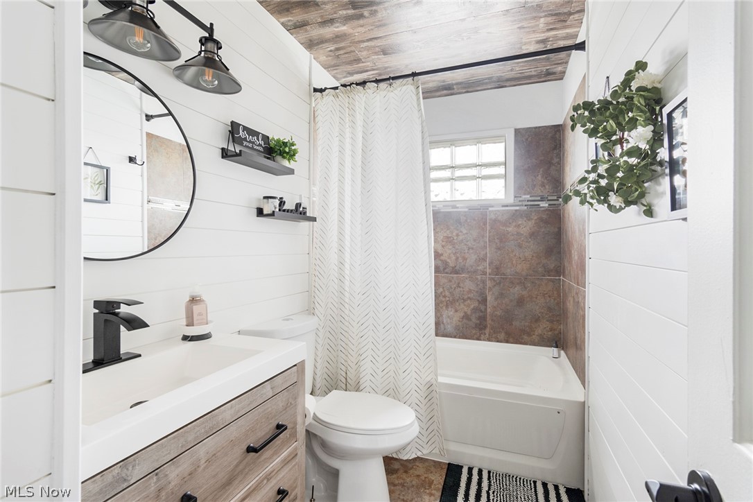 3792 South Raccoon Road Canfield, OH 44406 - Photo 22 of 39 Full bathroom featuring wooden ceiling, wooden walls, vanity, and toilet