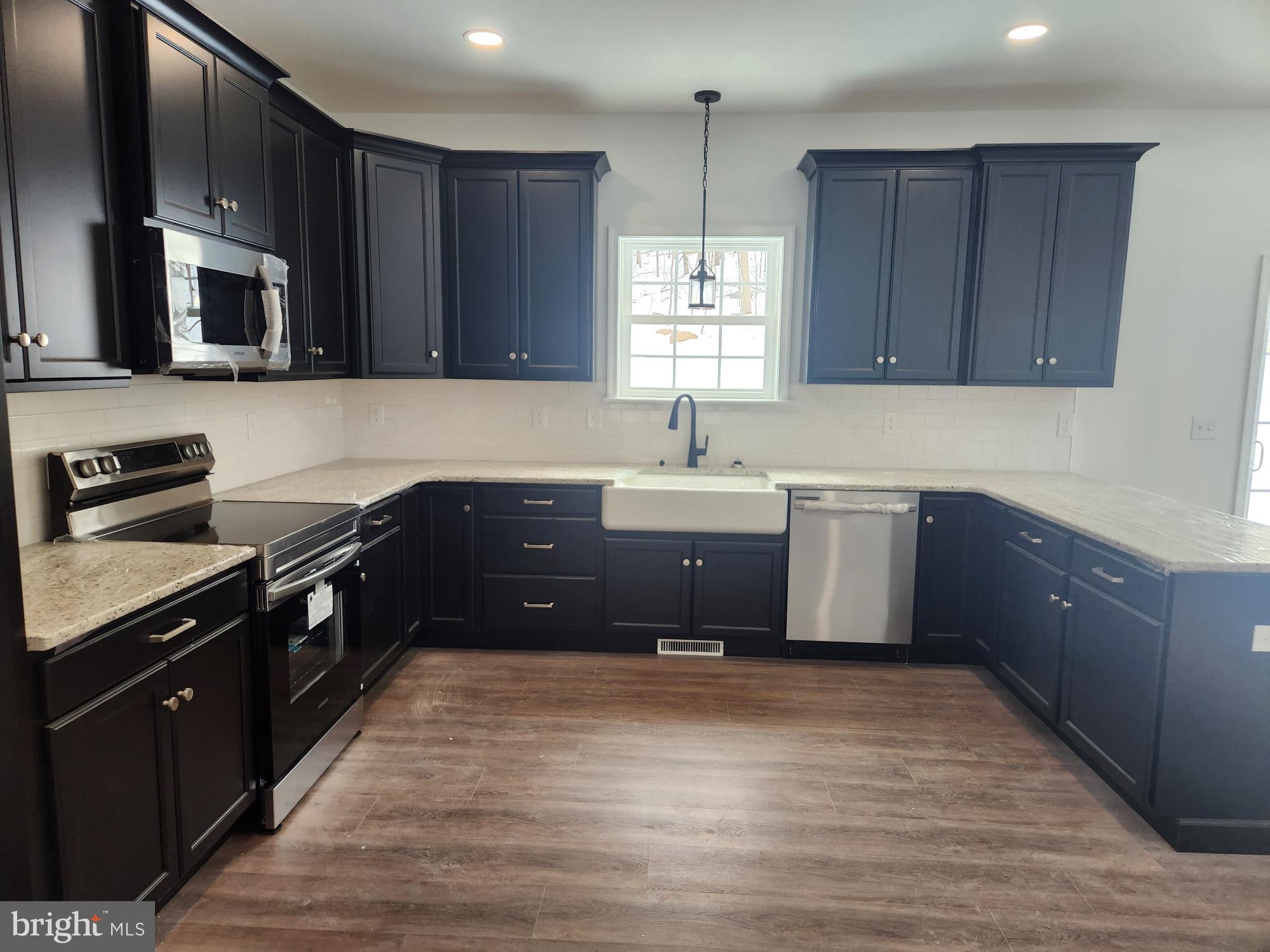 1929 Dunkleberger Road Elliottsburg, PA 17024 - Photo 3 of 48 Modern kitchen with sleek black cabinetry.