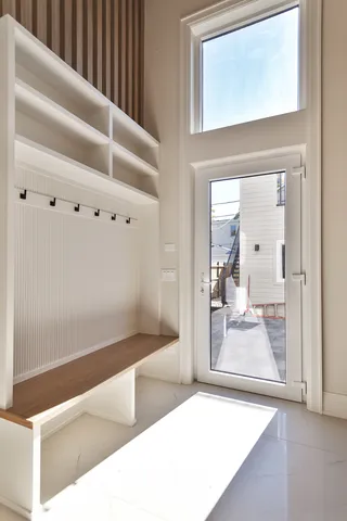 a dining room with furniture and a large window