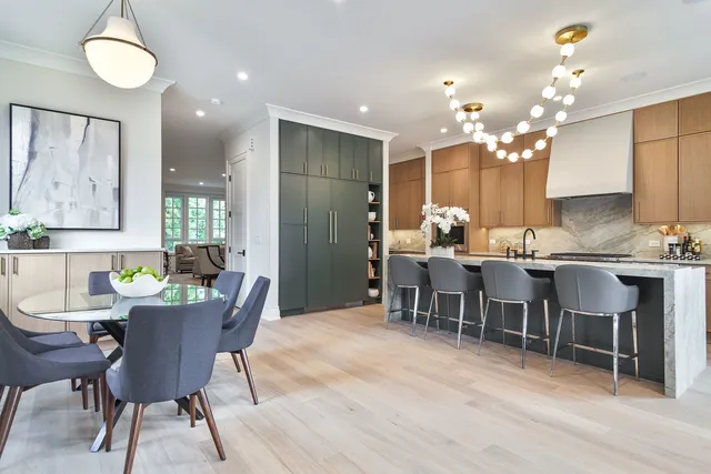 a kitchen with kitchen island granite countertop a table and chairs in it