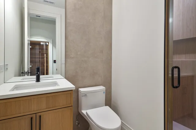 a kitchen with white cabinets and a window