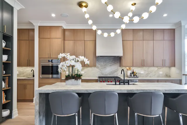 a kitchen with kitchen island granite countertop a sink cabinets and stainless steel appliances