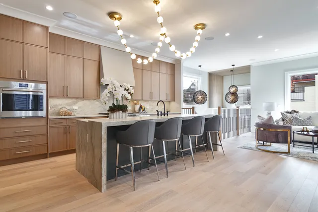 a kitchen with kitchen island granite countertop stove top oven microwave and cabinets