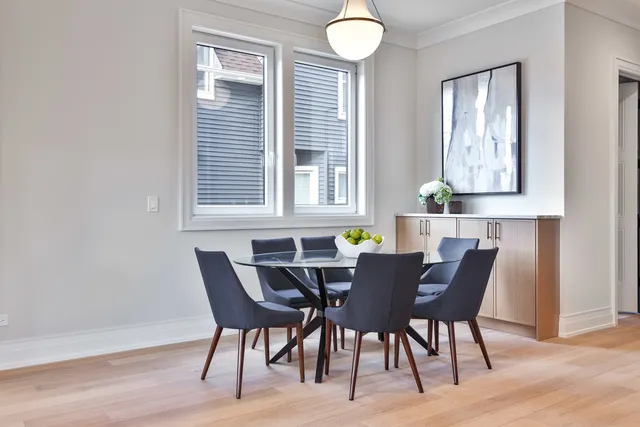a living room with furniture a fireplace and a large window