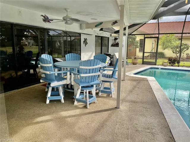 a view of a patio with a table and chairs