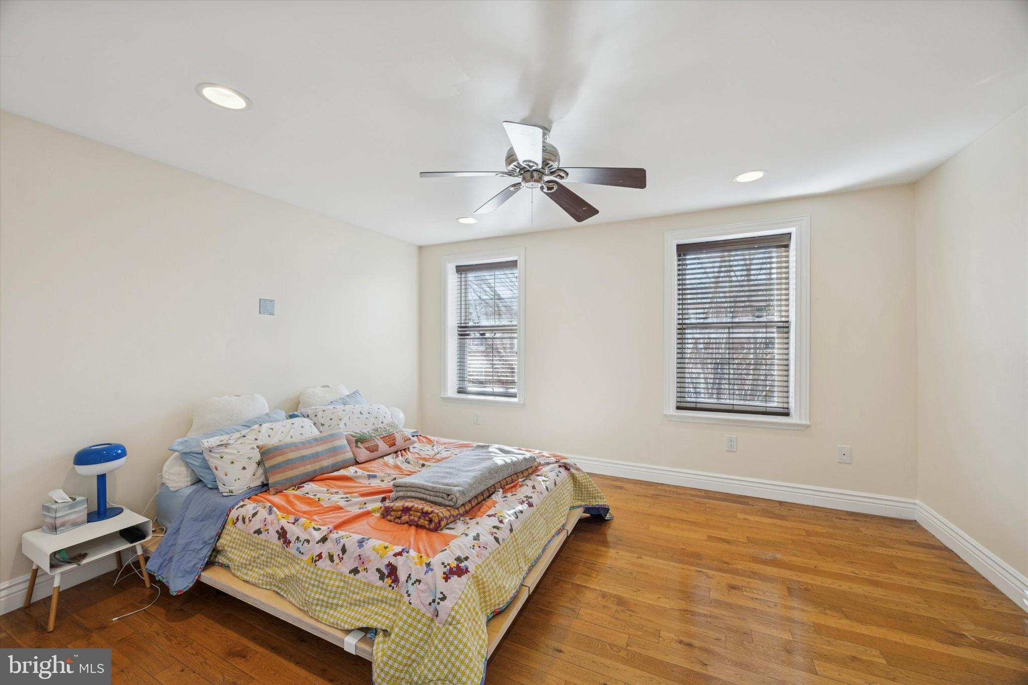 341 Dickinson Street Philadelphia, PA 19147 - Photo 15 of 27 a bedroom with a bed and wooden floor