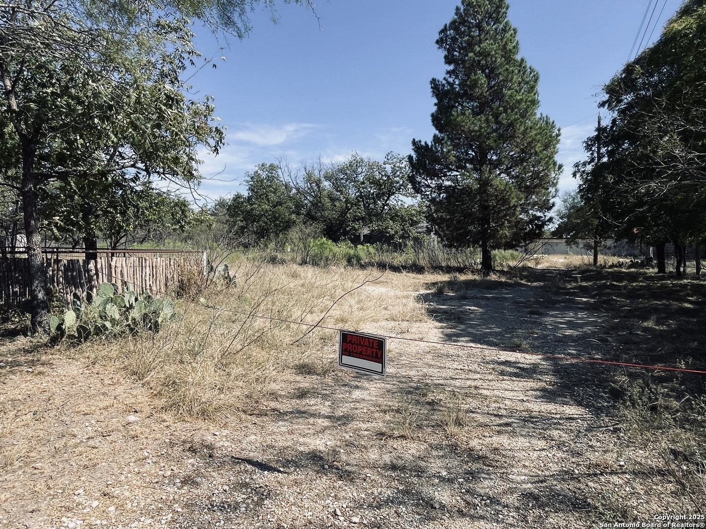 402 North Llano Street Junction, TX 76849 - Photo 3 of 8 a backyard of a house with lots of green space