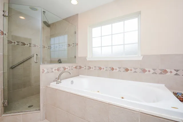 a bathroom with a bathtub and shower