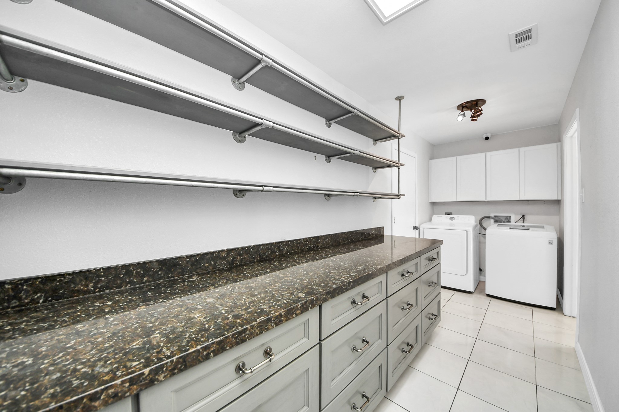 28707 Stapleford Street Spring, TX 77386 - Photo 17 of 38 a kitchen with granite countertop a sink a stove and cabinets