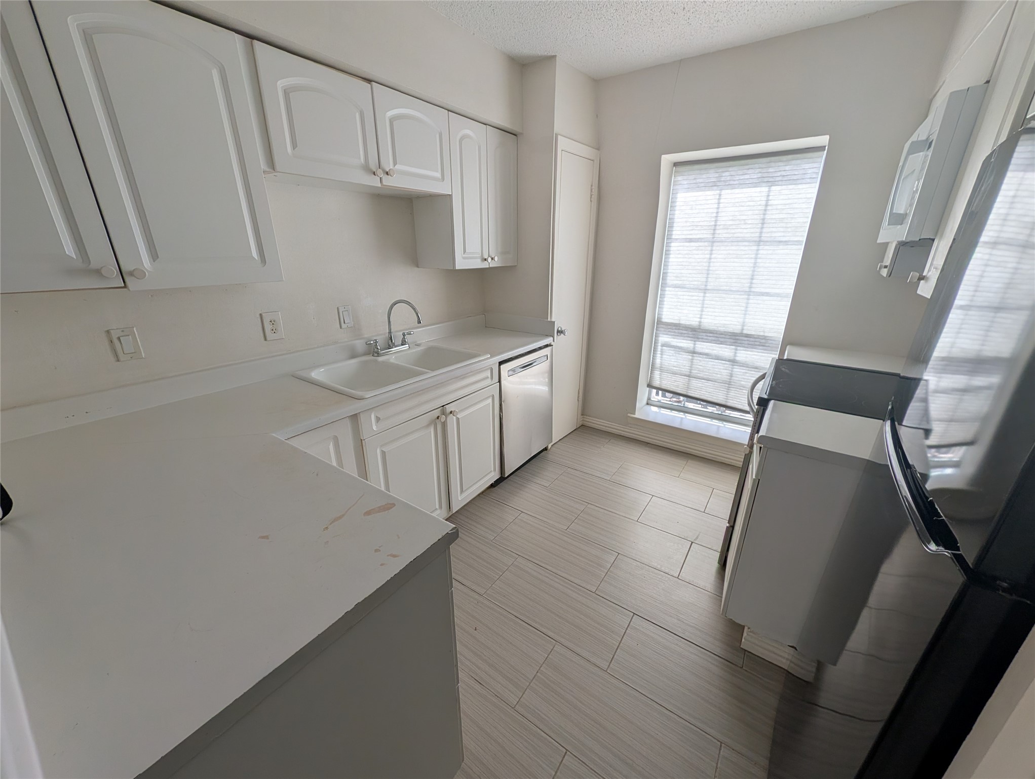 9017 Rue Cambon Street, Unit 98 Houston, TX 77074 - Photo 3 of 11 a kitchen with a sink cabinets and window