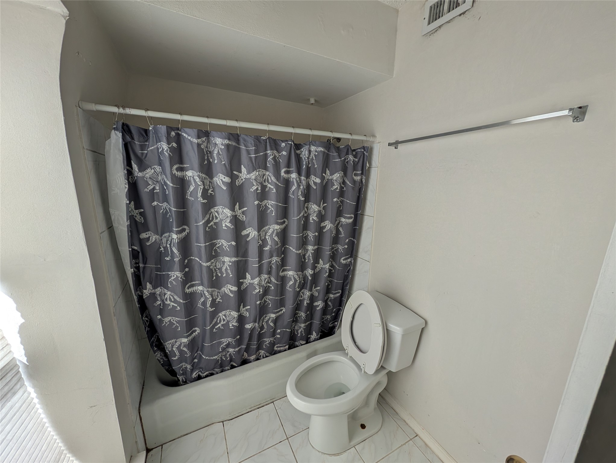 9017 Rue Cambon Street, Unit 98 Houston, TX 77074 - Photo 6 of 11 a white toilet sitting next to a shower curtain