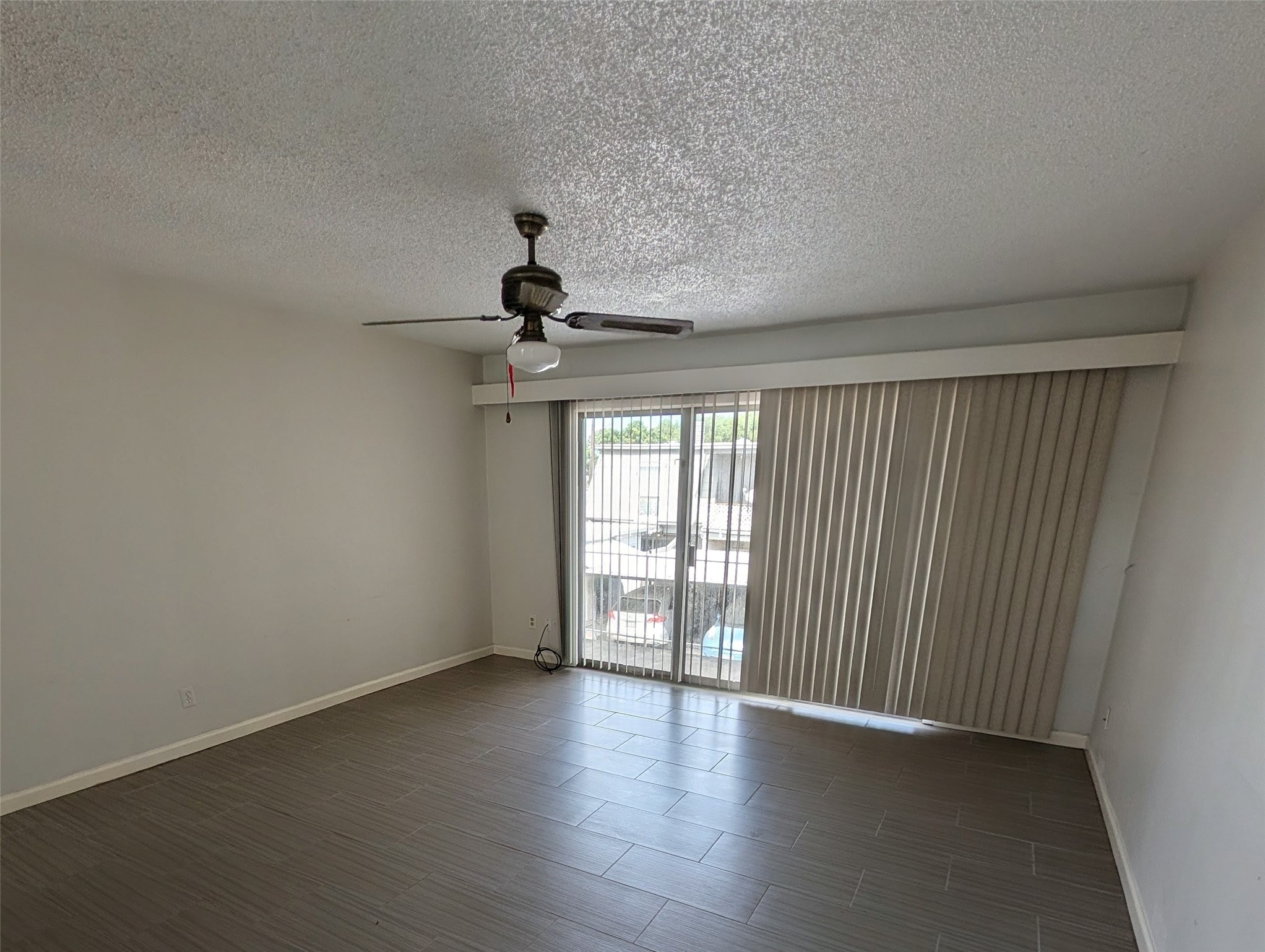 9017 Rue Cambon Street, Unit 98 Houston, TX 77074 - Photo 7 of 11 wooden floor in an empty room with a window
