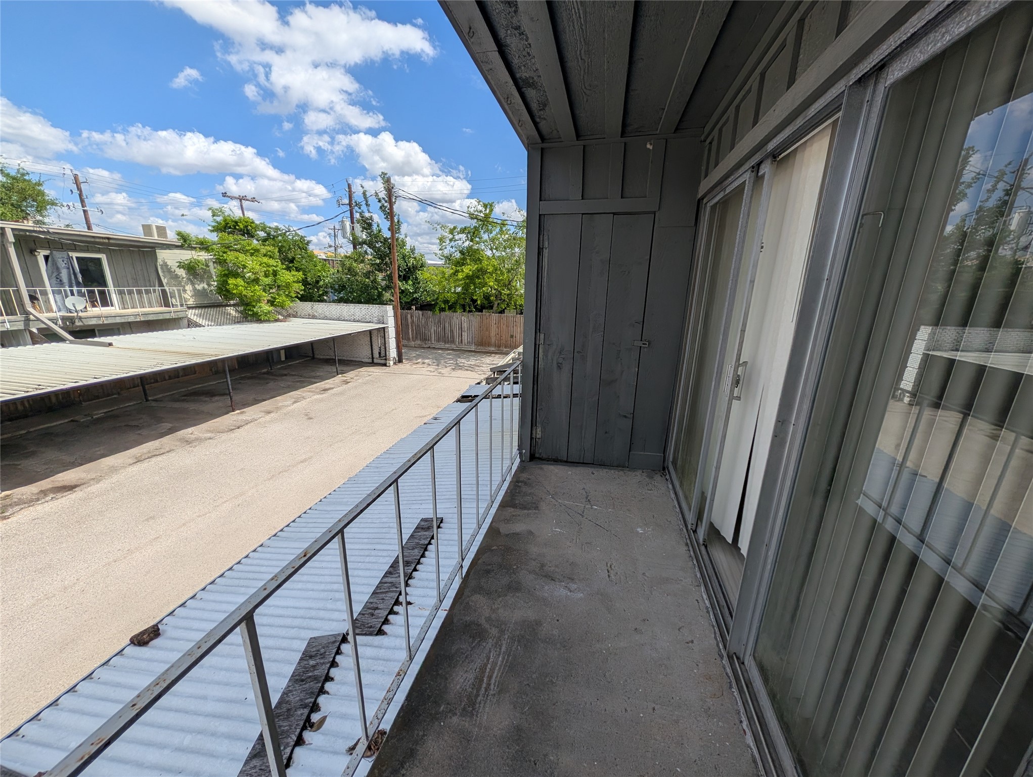 9017 Rue Cambon Street, Unit 98 Houston, TX 77074 - Photo 8 of 11 a view of balcony with wooden floor and fence