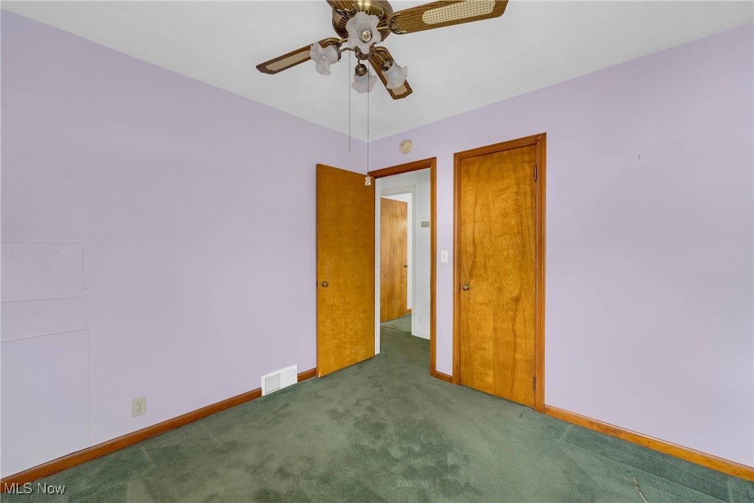 390 Hilliard Road Elyria, OH 44035 - Photo 16 of 30 Carpeted spare room featuring baseboards and a ceiling fan