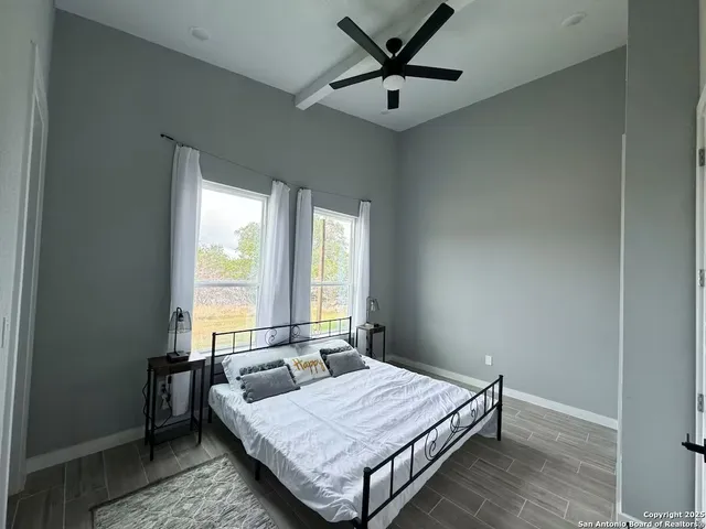a bedroom with a bed and window