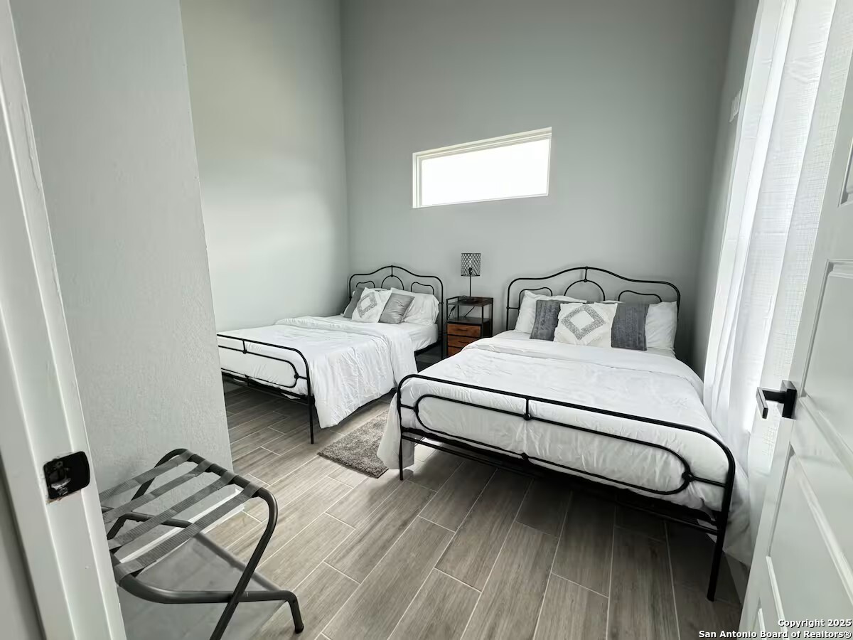 1652 Rimrock Cove Spring Branch, TX 78070 - Photo 18 of 26 a bedroom with two beds and a window