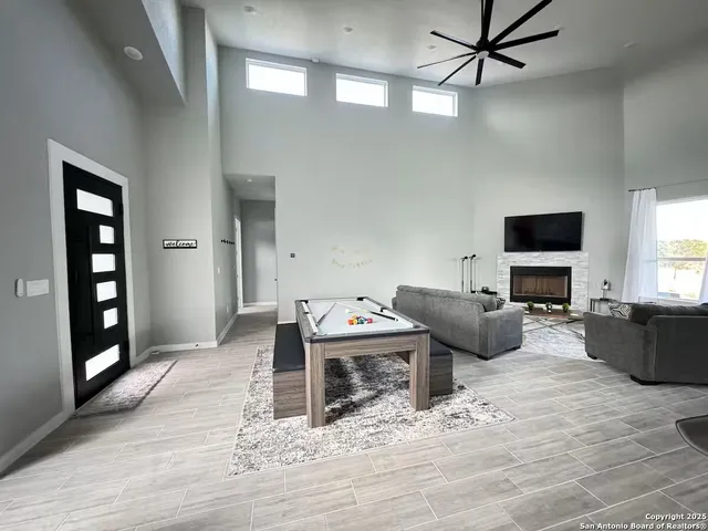 a living room with furniture a flat screen tv and a fireplace