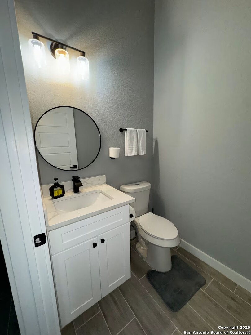 1652 Rimrock Cove Spring Branch, TX 78070 - Photo 10 of 26 a bathroom with a sink toilet and a mirror