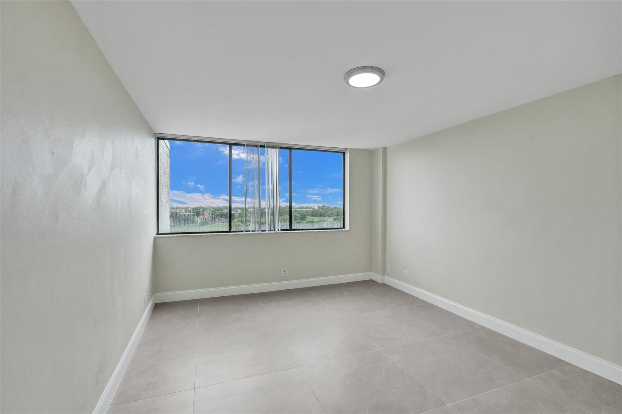 4222 Inverrary Boulevard, Unit 4810 Lauderhill, FL 33319 - Photo 46 of 63 a view of an empty room with a window