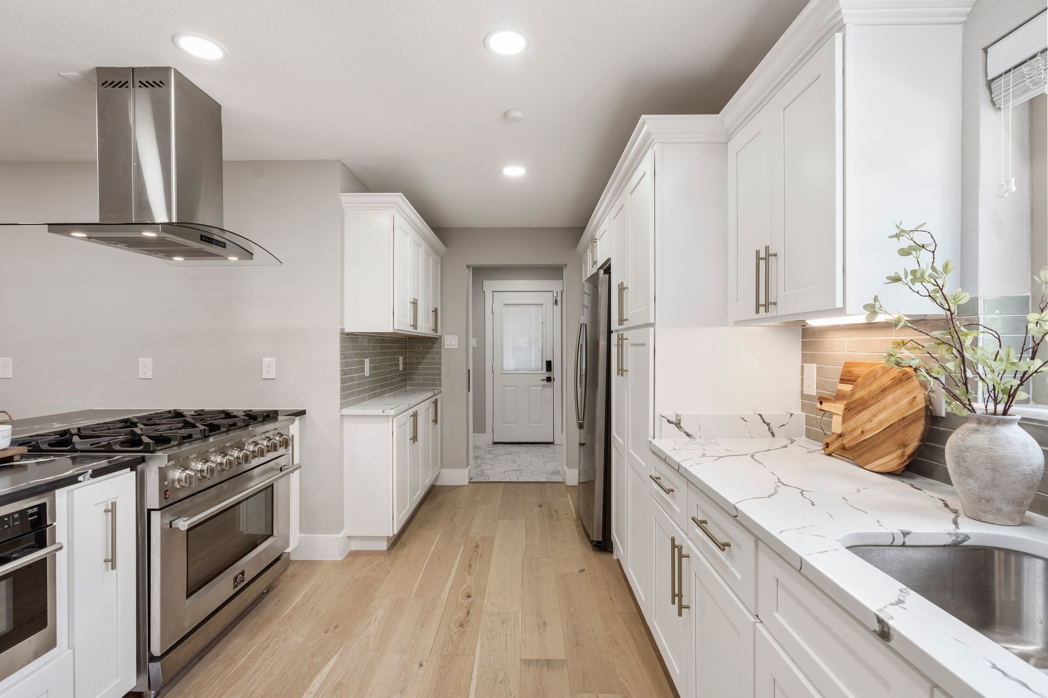 4423 Apollo Street Houston, TX 77018 - Photo 8 of 34 The chefs kitchen is light and bright with white cabinetry and quartz countertops.