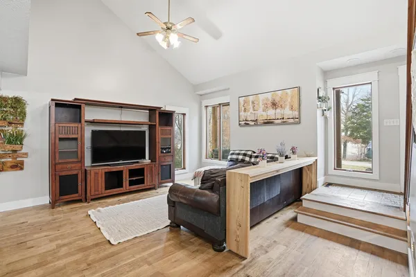a living room with furniture a wooden floor and a chandelier
