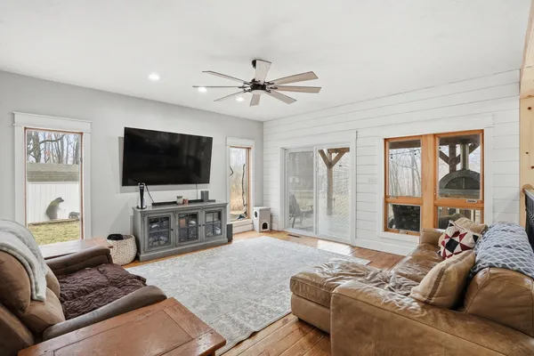a bathroom with a glass door shower and mirror