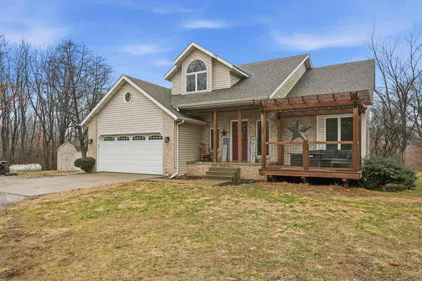 a front view of a house with a yard garage and outdoor seating