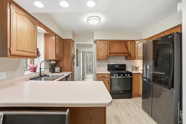 a kitchen with a sink stove and cabinets