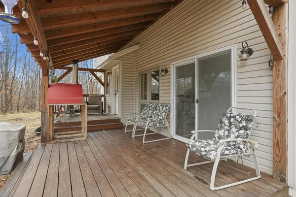 a view of a chairs and table in the balcony