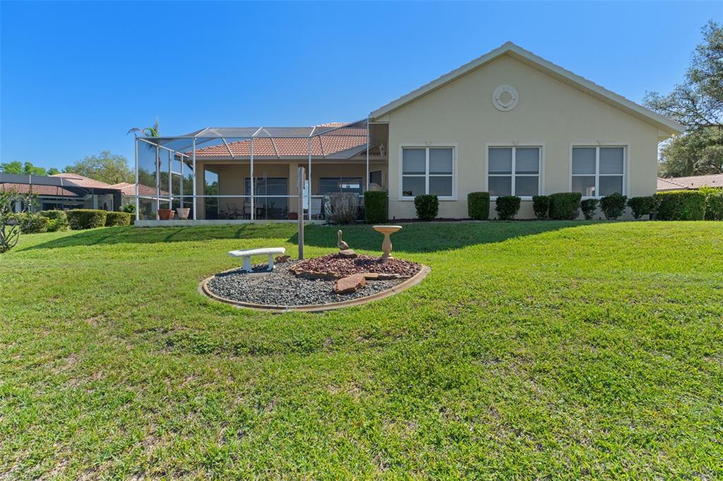 10081 Georgetown Court Weeki Wachee, FL 34613 - Photo 55 of 76 a view of a big house with a big yard and potted plants