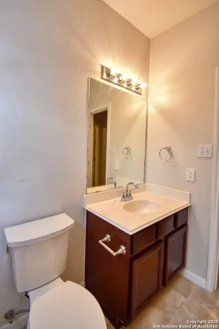 a bathroom with a toilet sink and mirror