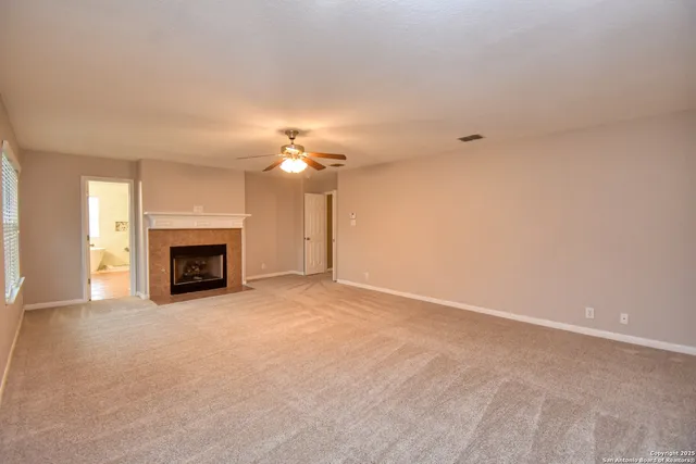 a living room with a fireplace and a fireplace