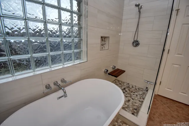 a bathroom with a bathtub and shower