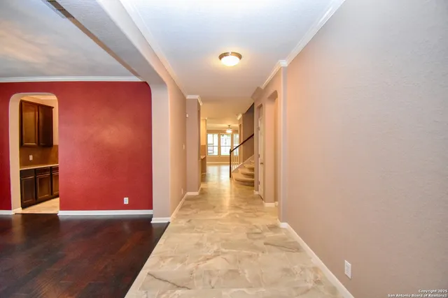 a view of a hallway with wooden floor