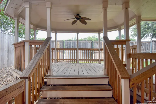 a view of a deck with a table and chairs next to a window with wooden floor