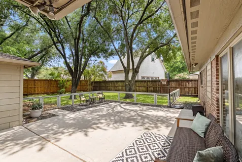 a view of a backyard with a large tree