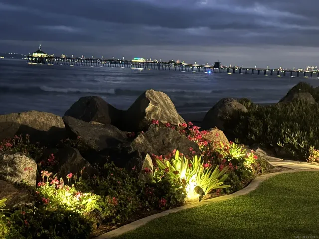 a bedroom with a bed and a large mirror with a flat tv screen
