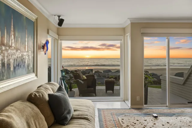 an outdoor sitting area with furniture and city view