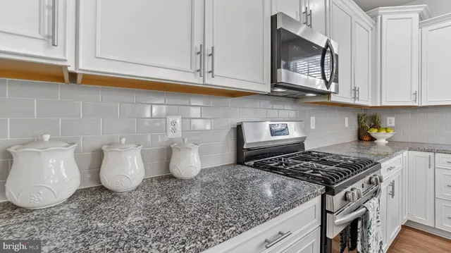 a kitchen with a stove and a cabinets