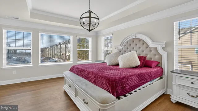 a bathroom with double vanity sinks a large mirror and a bathtub