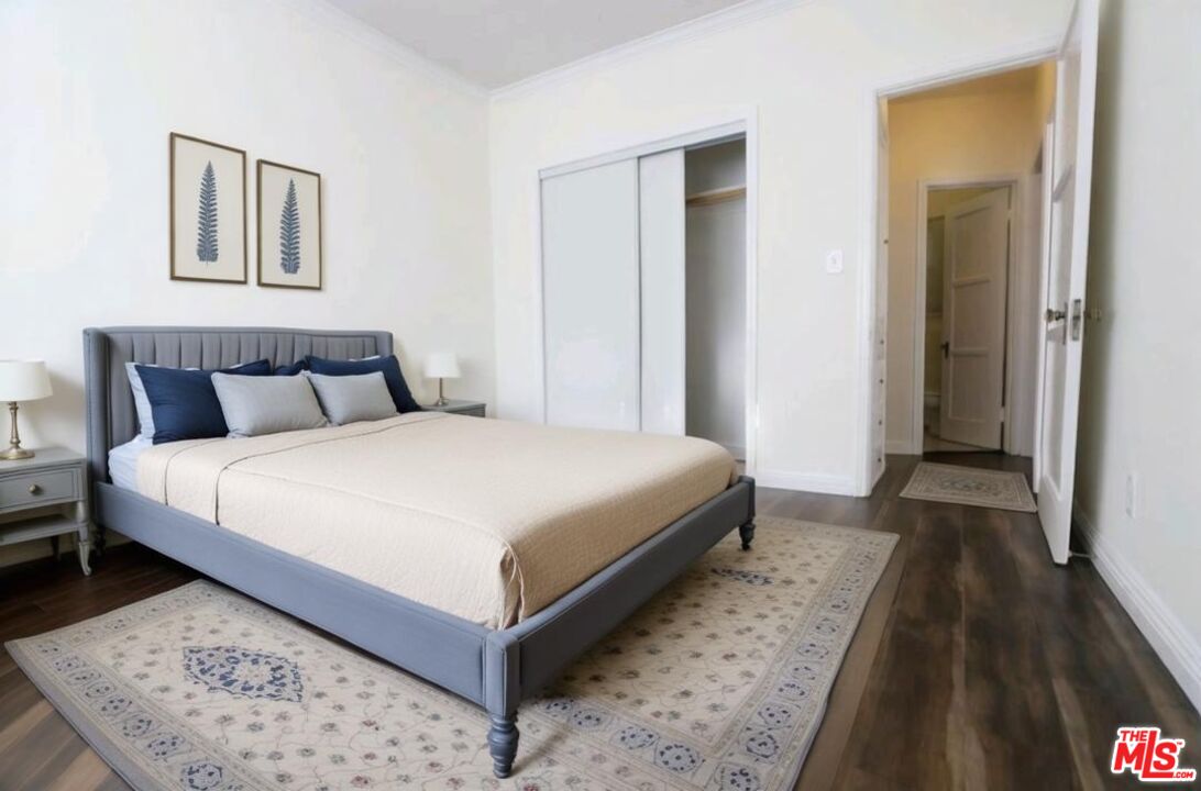 4124 Monroe Street Los Angeles, CA 90029 - Photo 19 of 29 a bedroom with a bed and a large mirror on a dresser