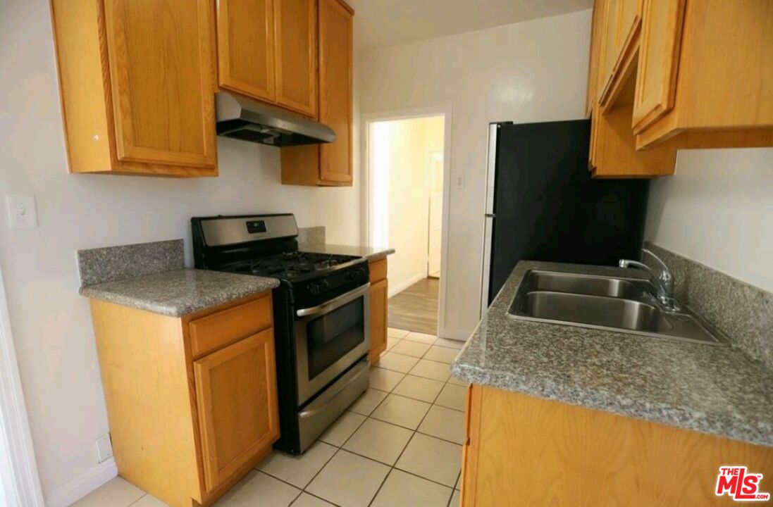 4124 Monroe Street Los Angeles, CA 90029 - Photo 5 of 29 a kitchen with stainless steel appliances granite countertop a sink stove and refrigerator