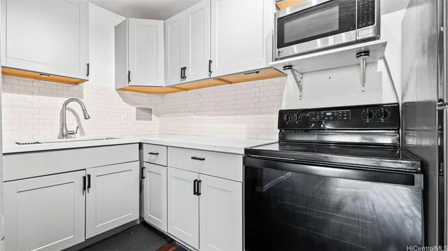a kitchen with cabinets and appliances