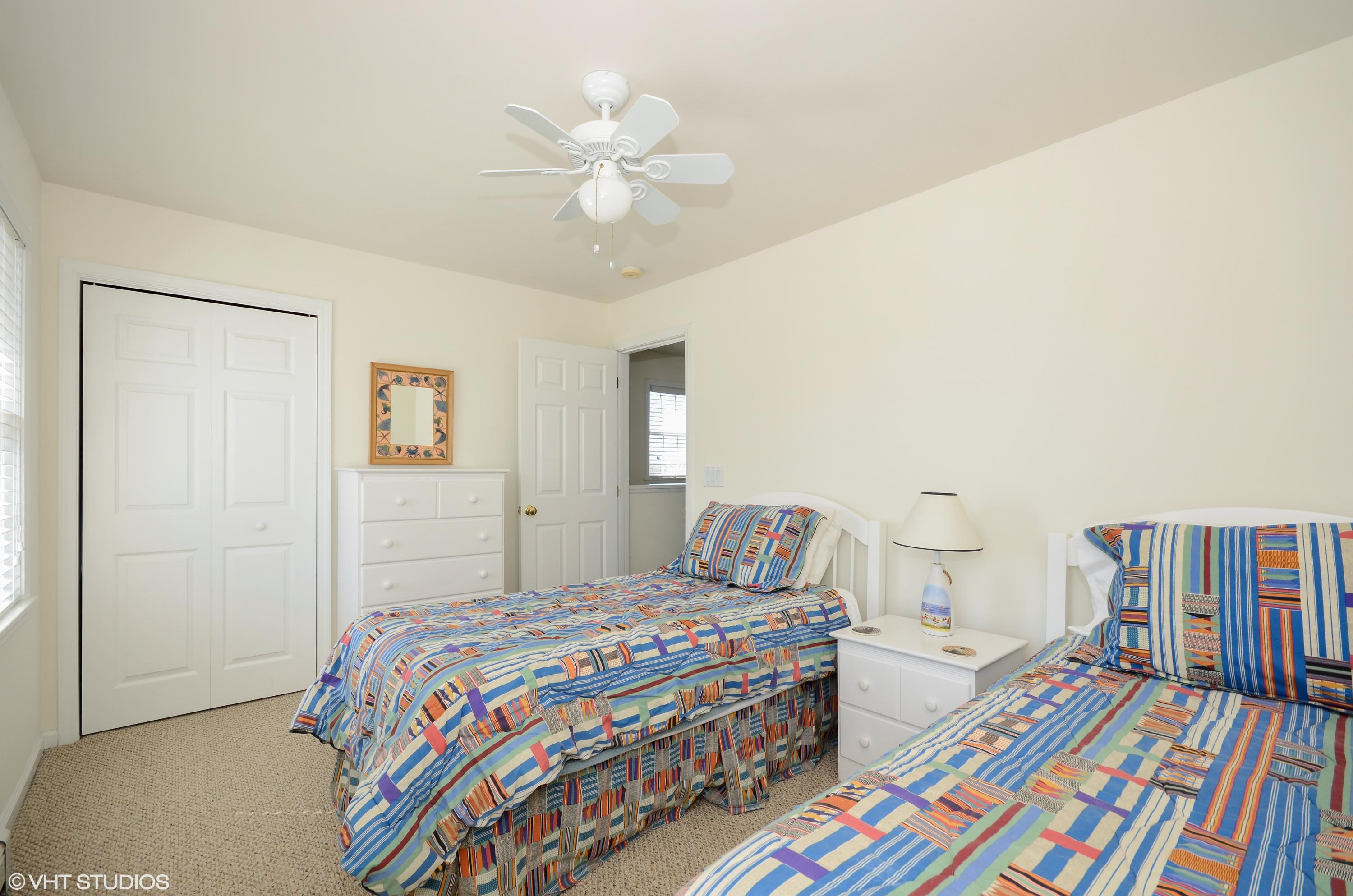 99 Mashnee Road Bourne, MA 02532 - Photo 18 of 25 a bedroom with a bed and a chandelier