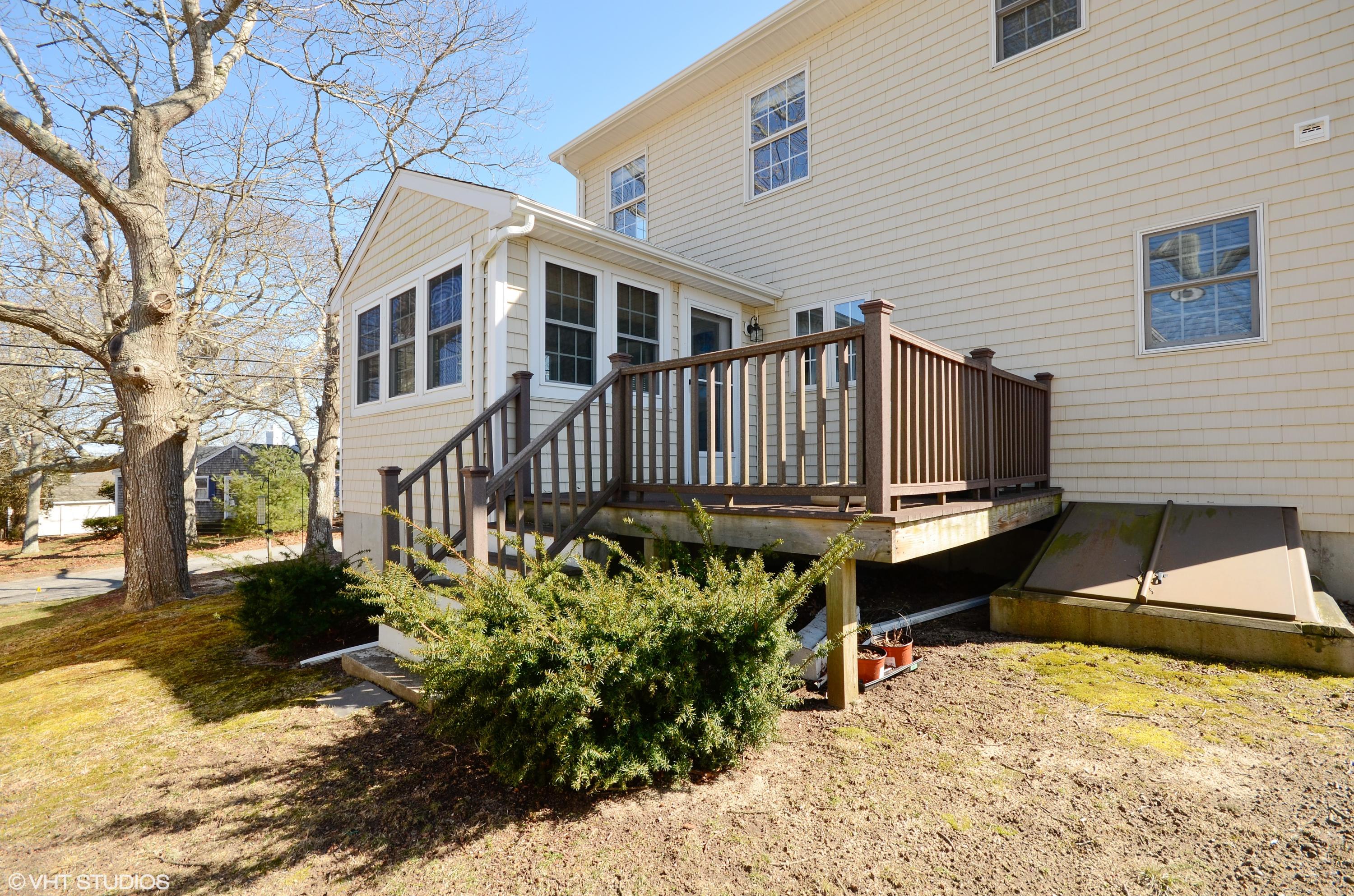 99 Mashnee Road Bourne, MA 02532 - Photo 20 of 25 a view of a house with a yard