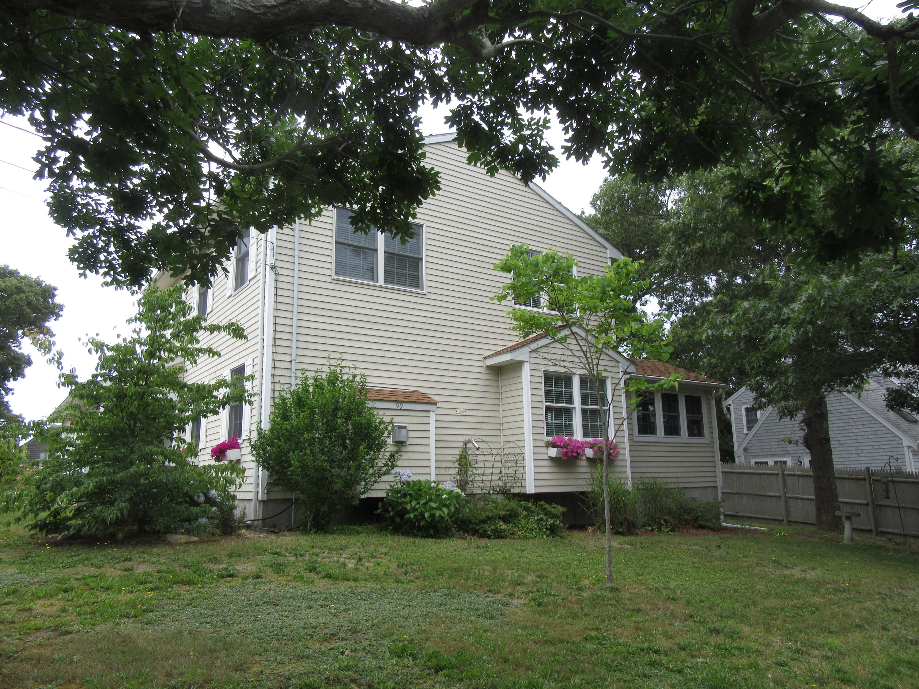 99 Mashnee Road Bourne, MA 02532 - Photo 2 of 25 a view of house with a yard and potted plants