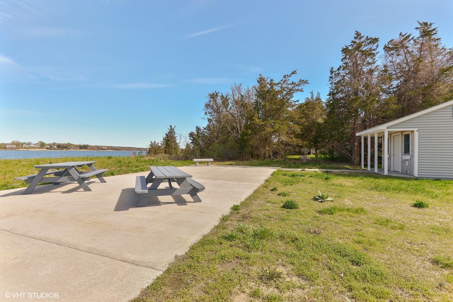 99 Mashnee Road Bourne, MA 02532 - Photo 23 of 25 a view of a swimming pool with an outdoor seating and a yard