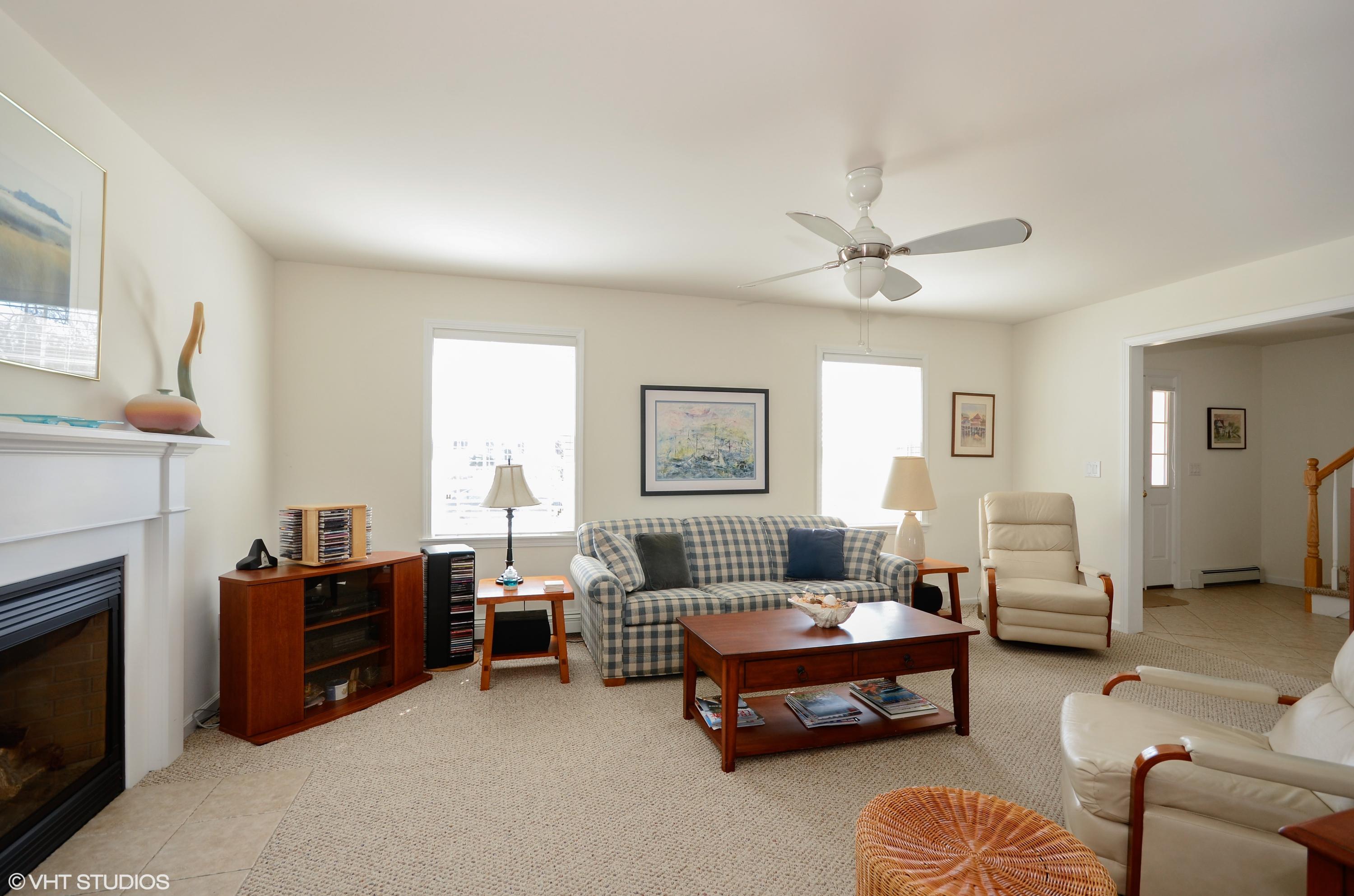 99 Mashnee Road Bourne, MA 02532 - Photo 7 of 25 a spacious bedroom with a bed a couch and a chandelier
